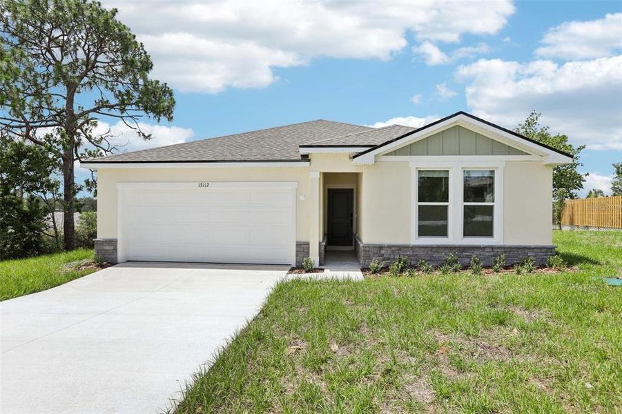 Front exterior of a new home in , Spring Hill, FL, highlighting curb appeal (Image 1).