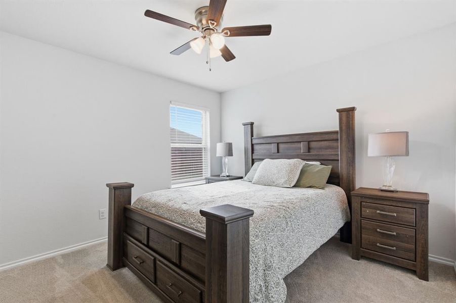 Bedroom featuring ceiling fan and light colored carpet