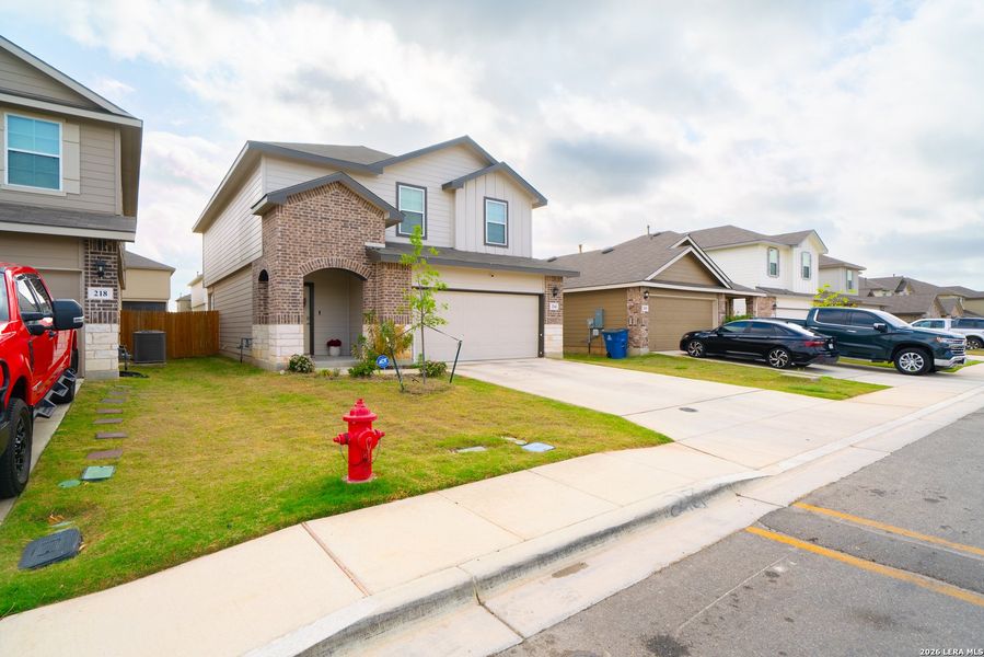 Front exterior of a new home in , Floresville, TX, highlighting curb appeal (Image 24).