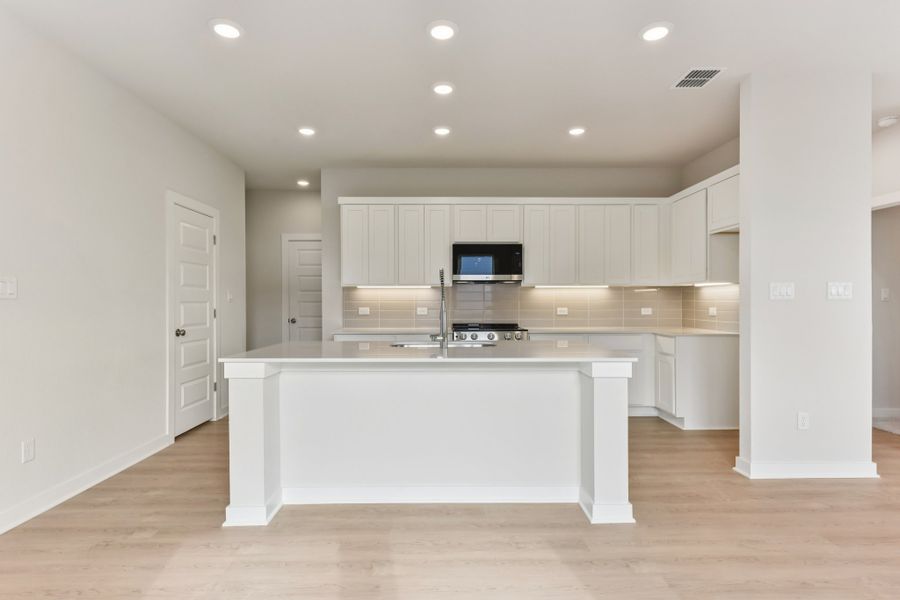 A kitchen with white cabinets. A kitchen with white cabinets.