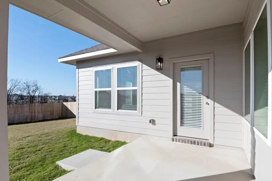 Doorway to property featuring a patio area