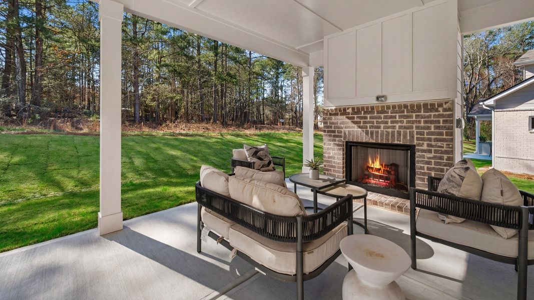 Spacious covered rear porch with fireplace Spacious covered rear porch with fireplace