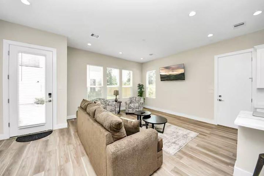 Multiple windows create a bright, welcoming living room with plenty of wall and floor space to make the room your own.