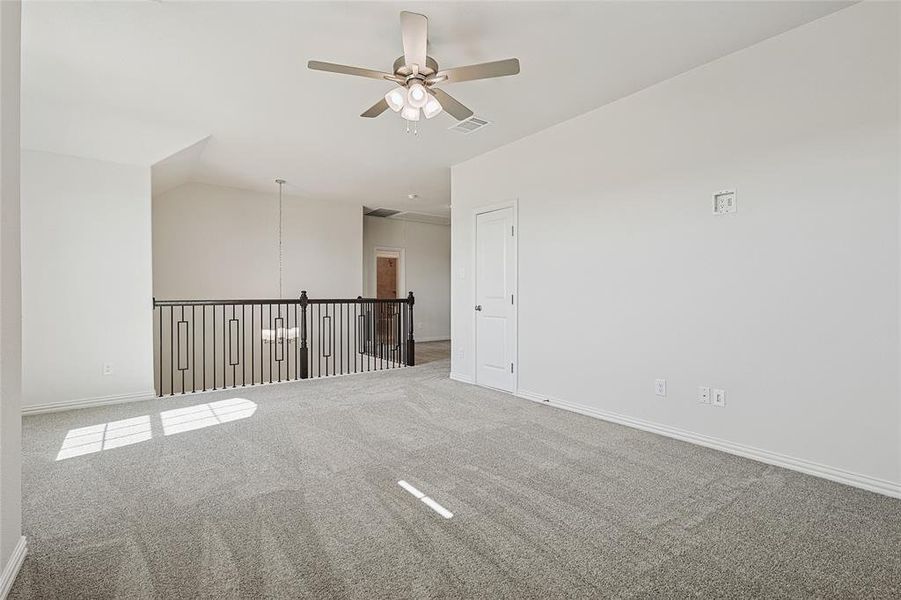 Unfurnished room with lofted ceiling, carpet floors, and ceiling fan