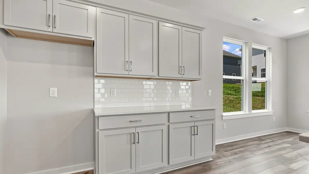 Open space for refrigerator combined with elevated touch of white quartz backsplash Open space for refrigerator combined with elevated touch of white quartz backsplash