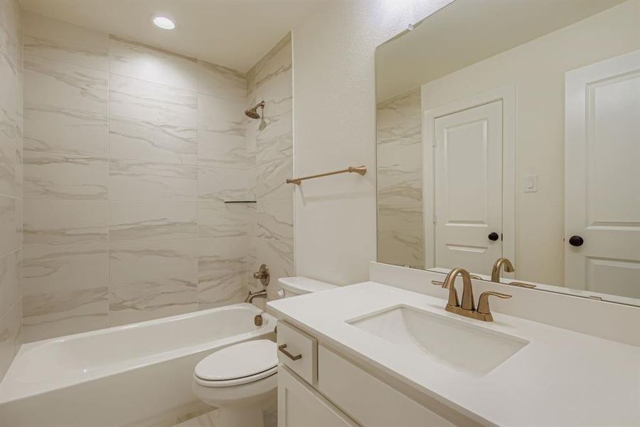 Bathroom featuring washtub / shower combination and vanity