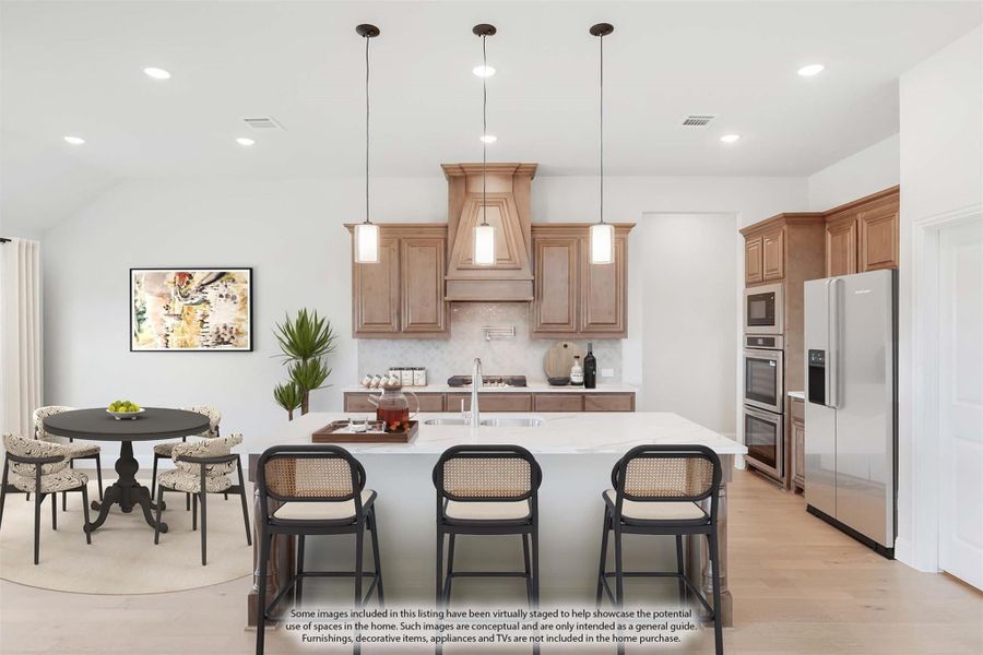 Kitchen with large island, wood cabinets, stainless appliances, and adjacent dining area with round table. Kitchen with large island, wood cabinets, stainless appliances, and adjacent dining area with round table.