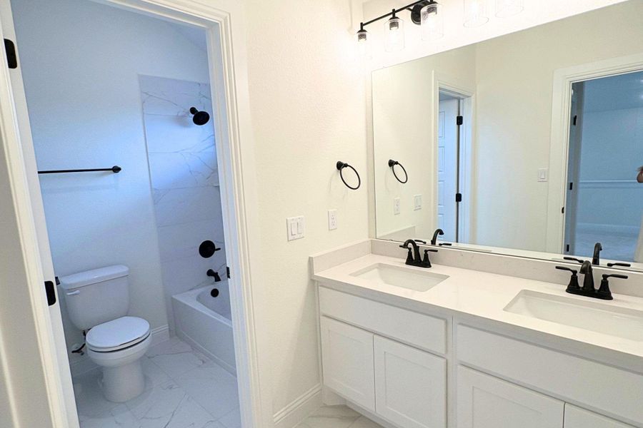 Clean lines and a dual vanity define this bright, updated bathroom space. Clean lines and a dual vanity define this bright, updated bathroom space.