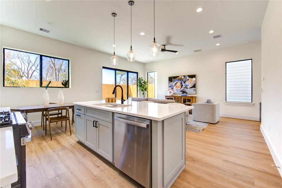 Modern open-concept kitchen seamlessly connects to the living and spacious breakfast areas.