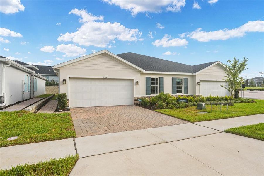 Front exterior of a new home in , Lady Lake, FL, highlighting curb appeal (Image 28). Front exterior of a new home in , Lady Lake, FL, highlighting curb appeal (Image 28).