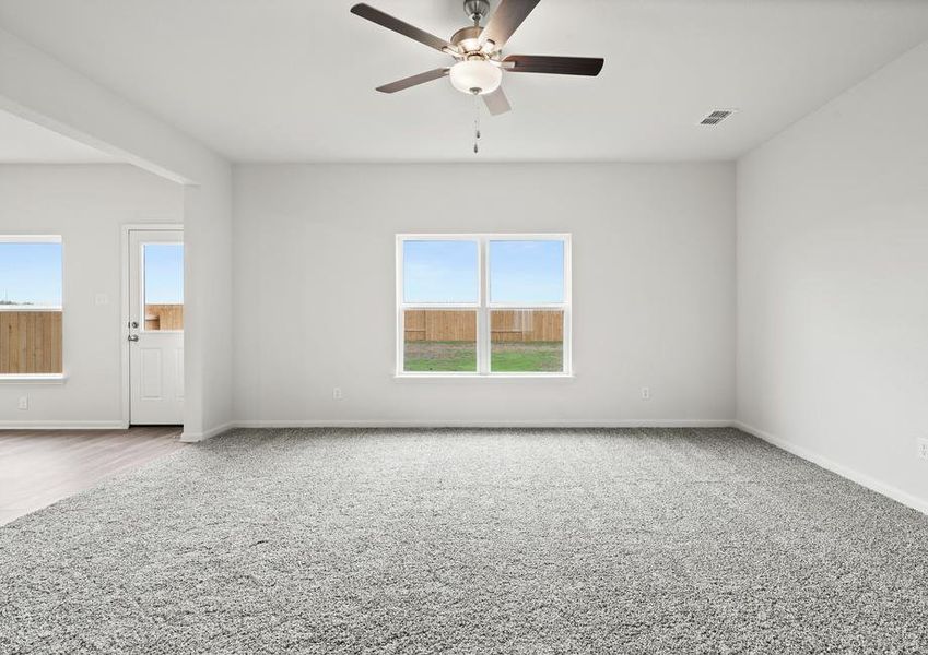 The family room of the Cypress has a large window with backyard views.