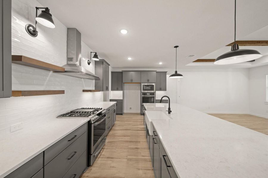 Gorgeous kitchen with grey cabinets and quartz countertops (*Photo not of actual home and used for illustration purposes only.)