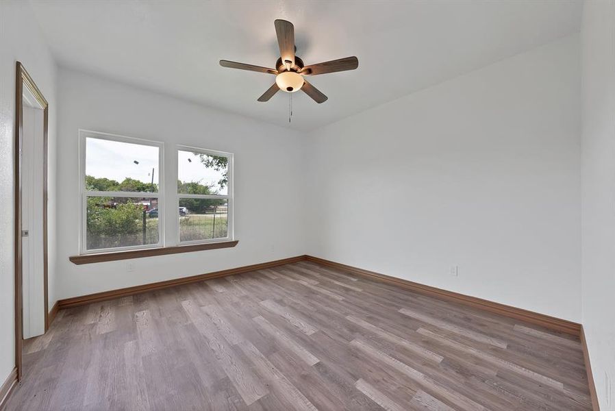 Empty room with light wood-style flooring and a ceiling fan