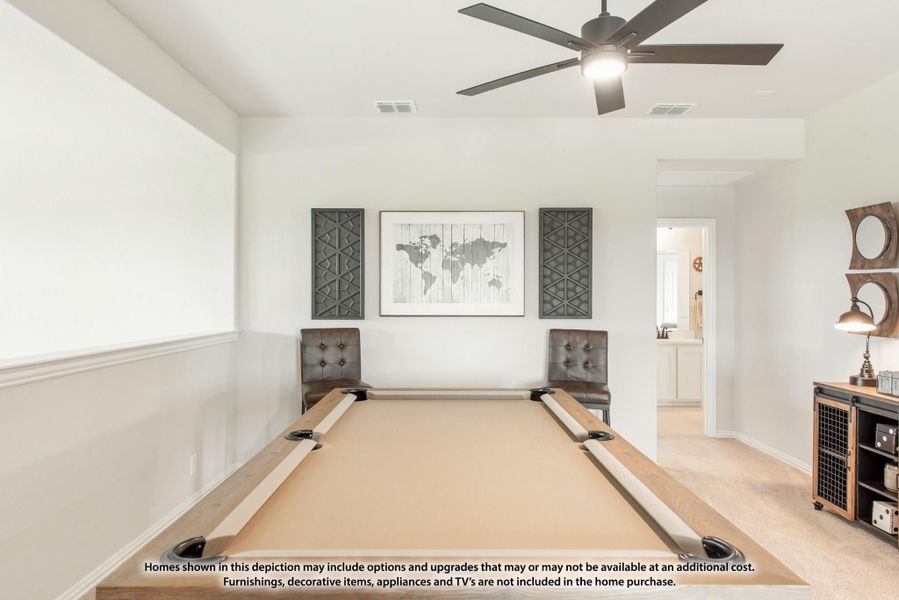 Game room with pool table, ceiling fan, and wall art on light carpet
