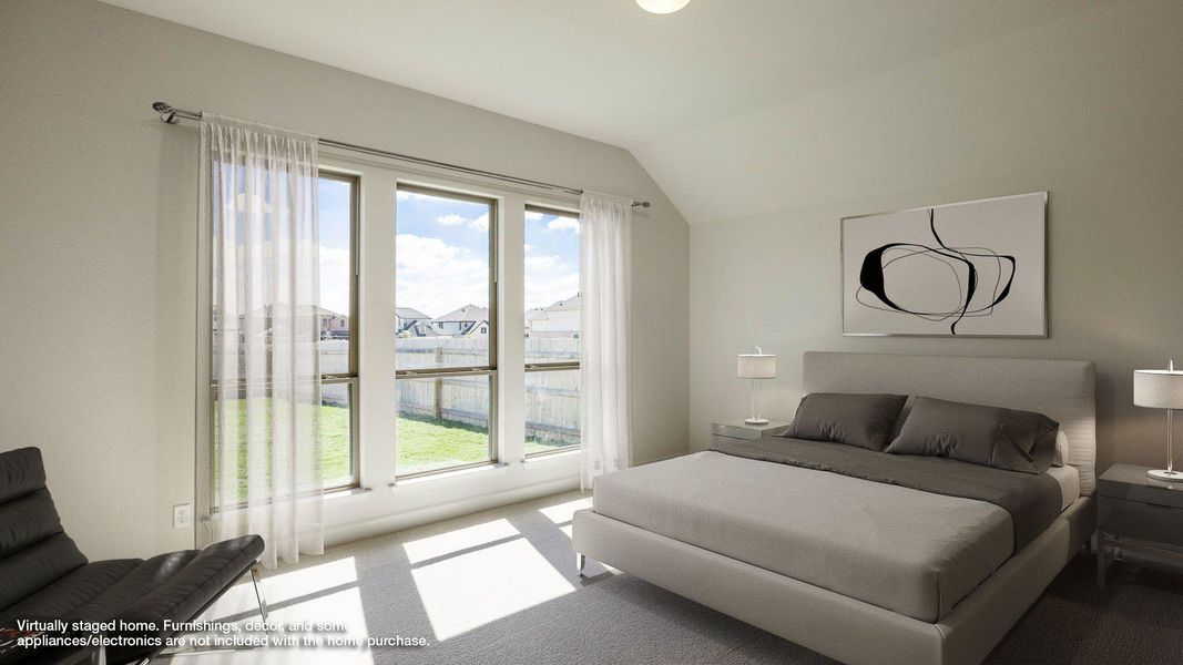 Bedroom with carpet floors and vaulted ceiling Bedroom with carpet floors and vaulted ceiling