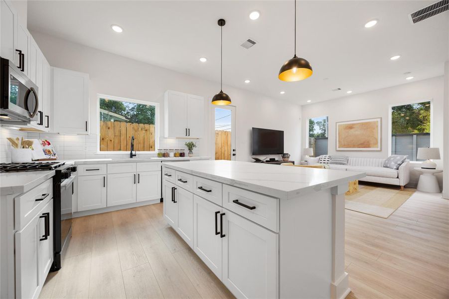 The open concept living space connects the living and kitchen areas—perfect for both everyday living and entertaining! *Virtually Staged