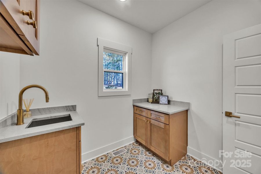 Spacious laundry room with sink and cabinetry Spacious laundry room with sink and cabinetry