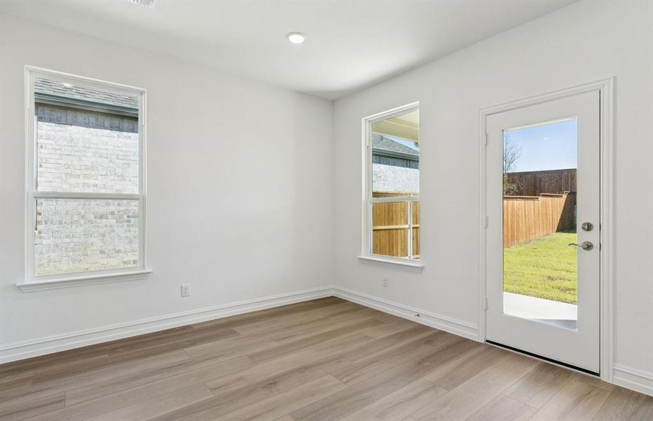 Dining nook off kitchen with access to backyard