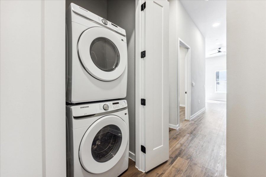 A dedicated laundry closet with modern stacked appliances, seamlessly integrated into the hallway. A dedicated laundry closet with modern stacked appliances, seamlessly integrated into the hallway.