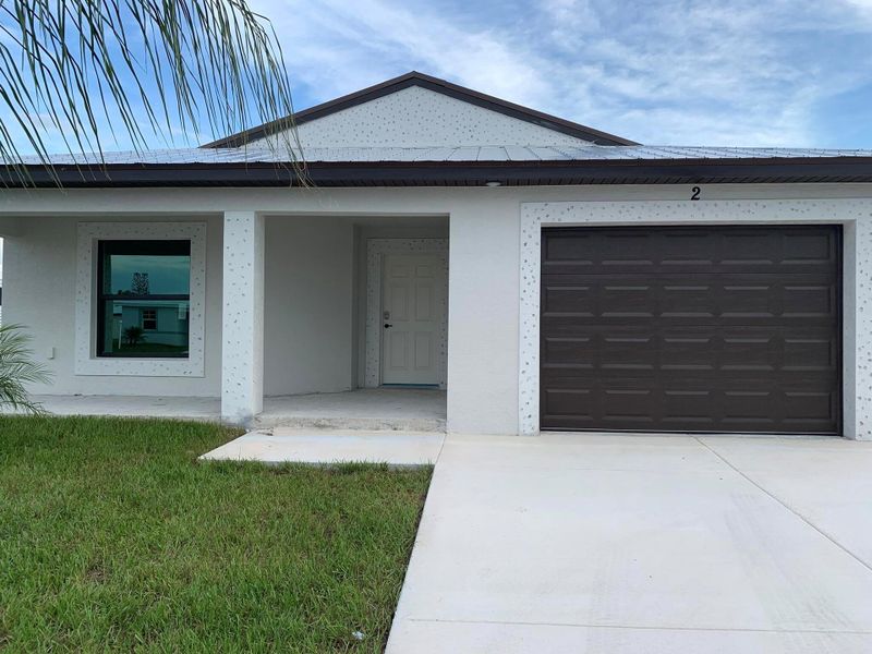 Front exterior of a new home in , Port St. Lucie, FL, highlighting curb appeal (Image 2).