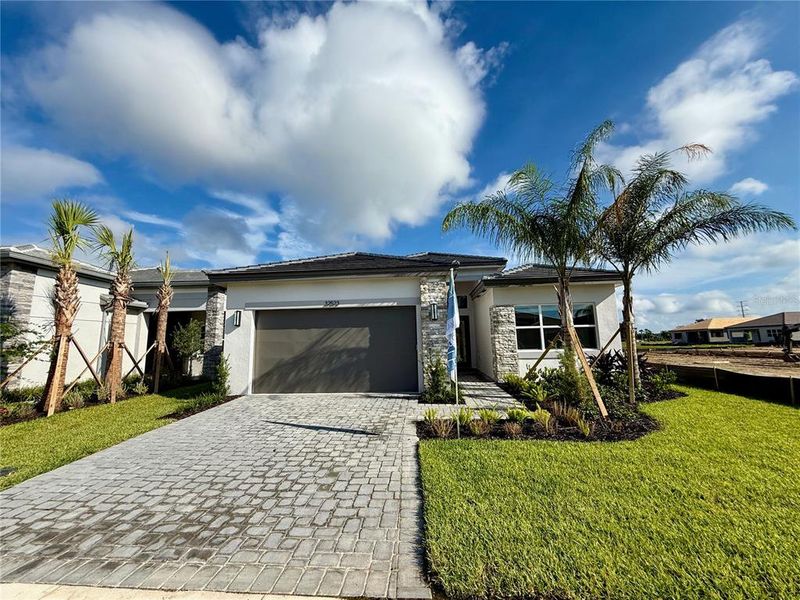 Front exterior of a new home in Valencia Ridge, Wesley Chapel, FL, highlighting curb appeal (Image 26).
