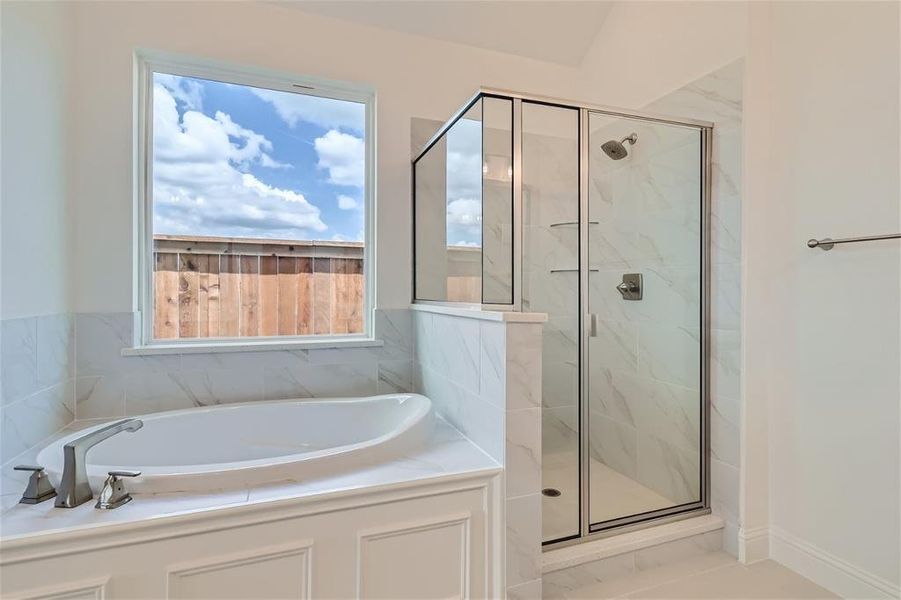 Bathroom with tile flooring and independent shower and bath