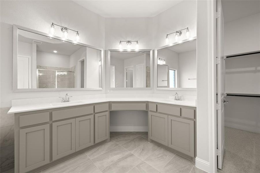 Bathroom with a stall shower, double vanity, and marble finish floors Bathroom with a stall shower, double vanity, and marble finish floors