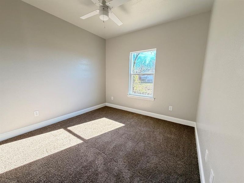 Spare bedroom #2 with carpet floors and a ceiling fan Spare bedroom #2 with carpet floors and a ceiling fan