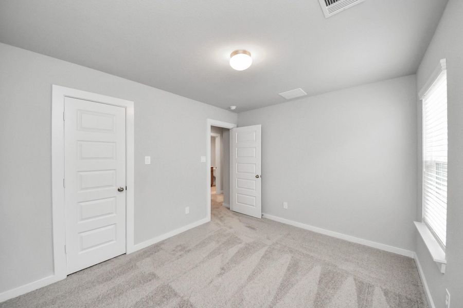 Generously sized secondary bedrooms featuring spacious closets, soft and inviting carpeting underfoot, large windows allowing plenty of natural light, and the added touch of privacy blinds for your personal retreat.