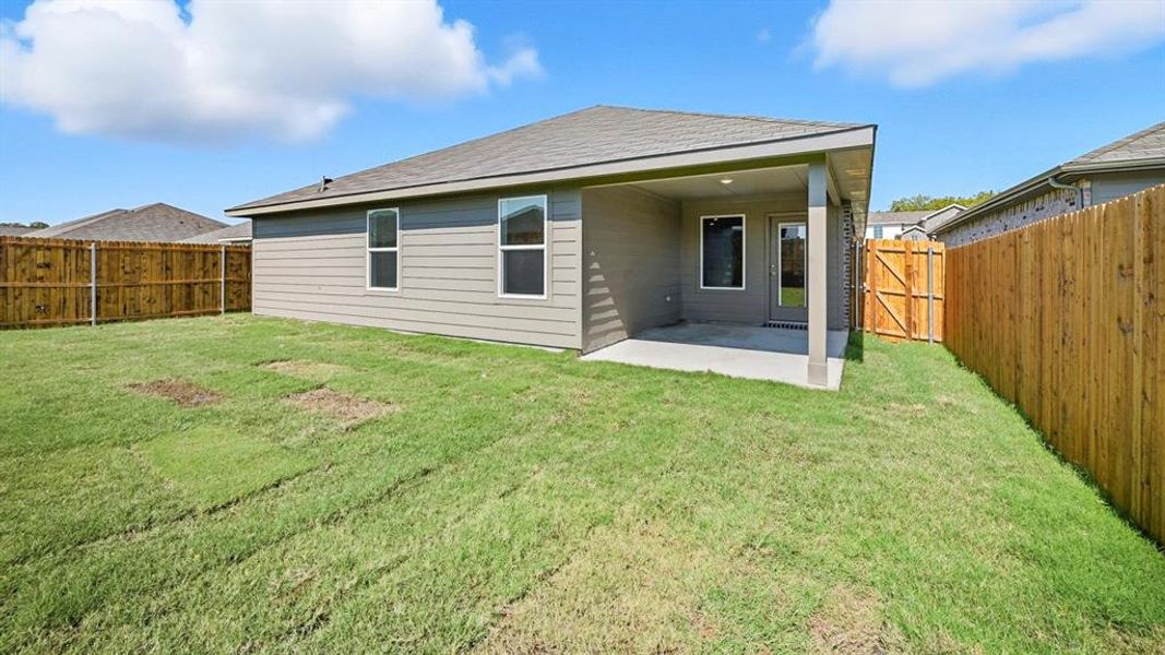 Back of property with a patio, a fenced backyard, a gate, and a shingled roof Back of property with a patio, a fenced backyard, a gate, and a shingled roof