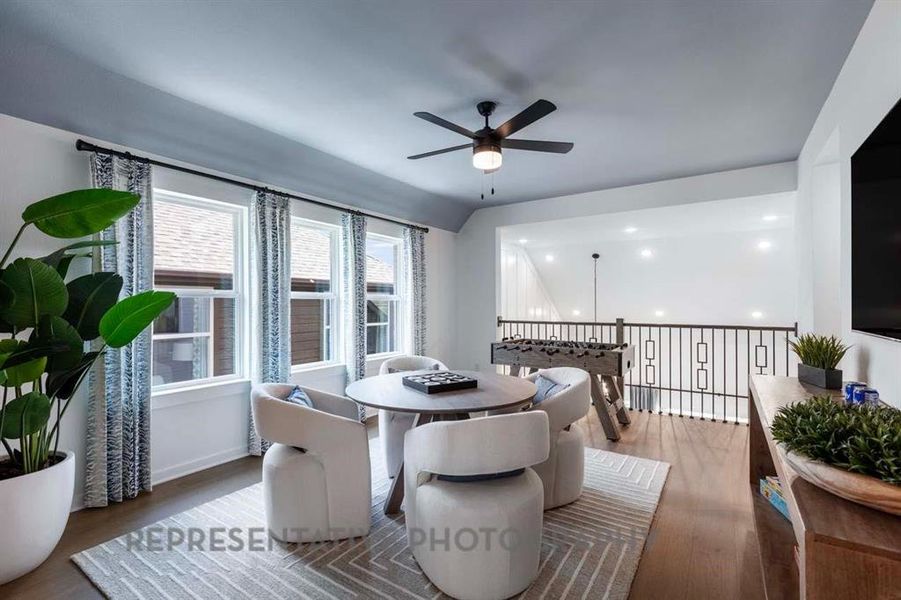 Dining area with dark wood-style flooring and a ceiling fan Dining area with dark wood-style flooring and a ceiling fan