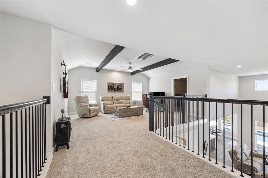 Bright and spacious upstairs lounge featuring plush seating, large windows with blinds, and stylish dark ceiling beams. Bright and spacious upstairs lounge featuring plush seating, large windows with blinds, and stylish dark ceiling beams.