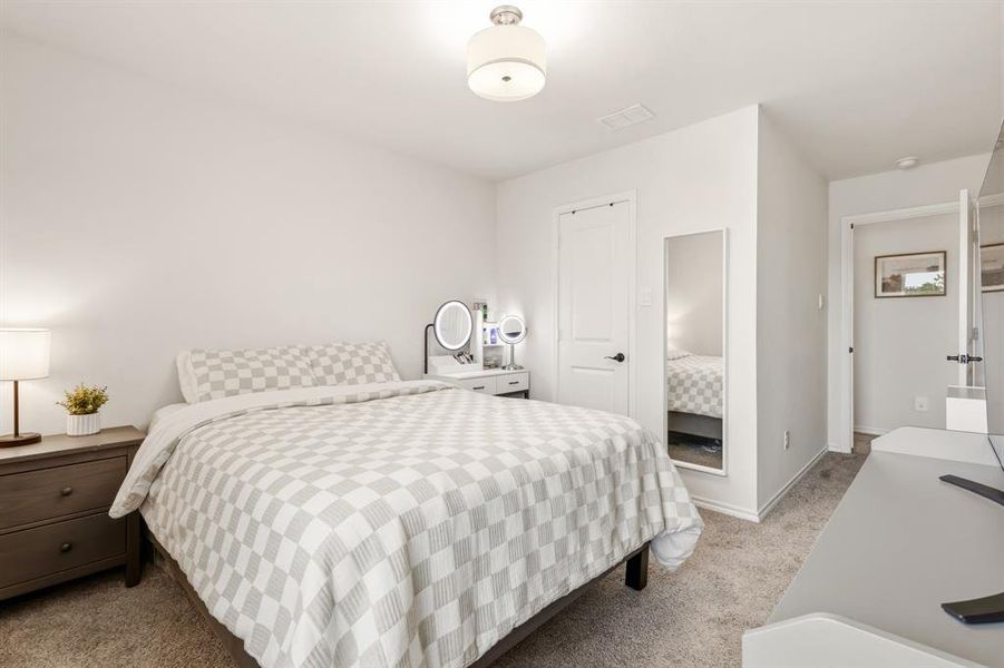 This room features a neutral color palette, a ceiling-mounted light fixture, and carpeted floors This room features a neutral color palette, a ceiling-mounted light fixture, and carpeted floors