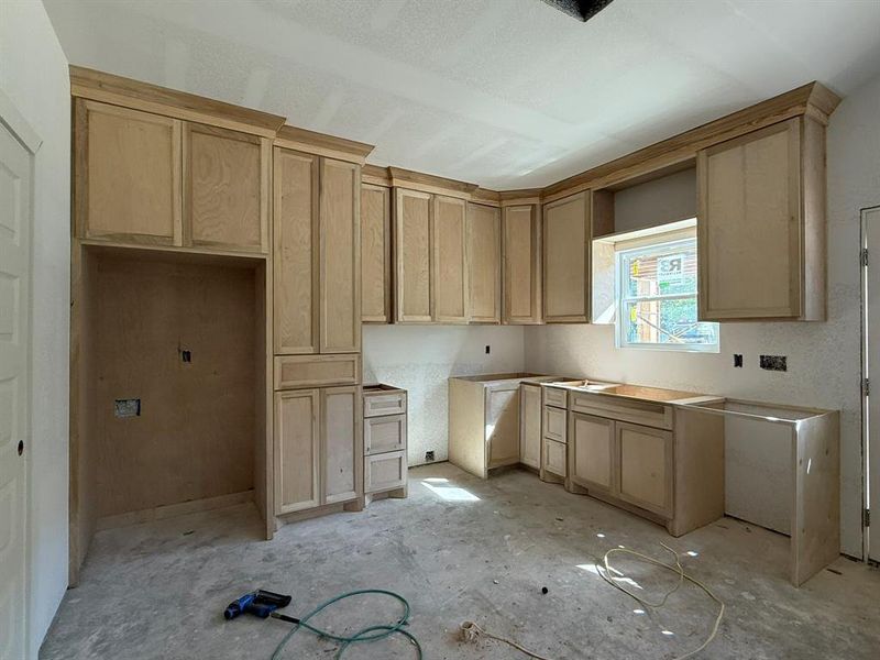 Kitchen featuring light brown cabinetry