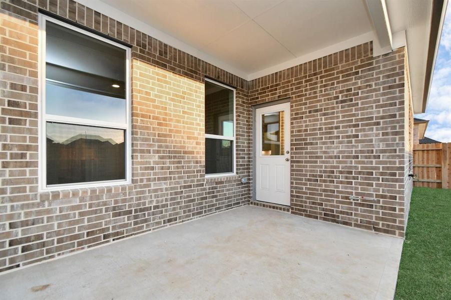 Experience outdoor living at its finest on this expansive covered patio, thoughtfully designed for BBQs and delightful outdoor dining. Sample photo of completed home with similar floor plan. As-built interior colors and selections may vary.