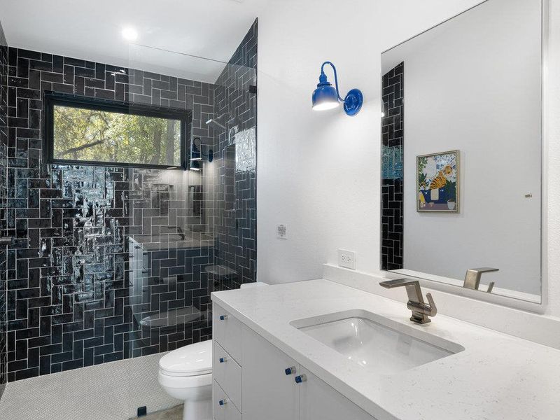 Bathroom with vanity and a tile shower