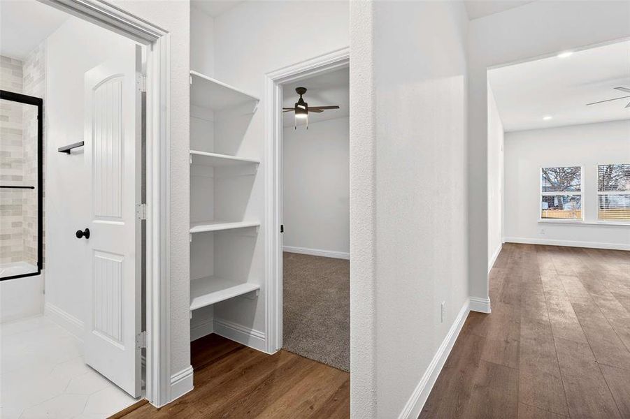Hallway featuring dark wood finished floors and baseboards