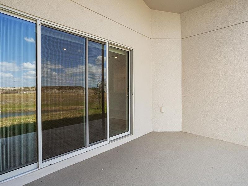 Your interior opens to outdoor living space on a covered lanai - Sophia by Highland Homes
