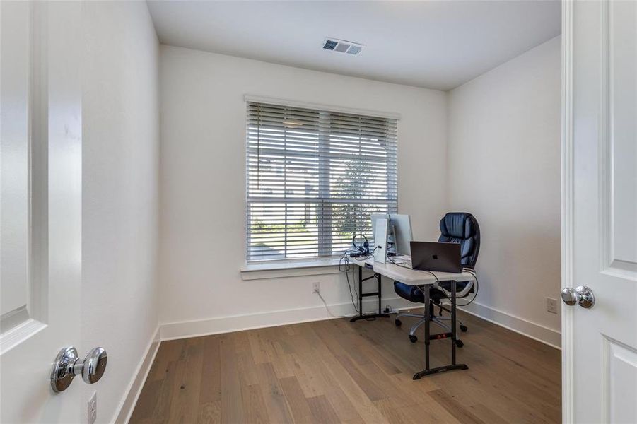 Home office with light wood-style flooring and baseboards Home office with light wood-style flooring and baseboards