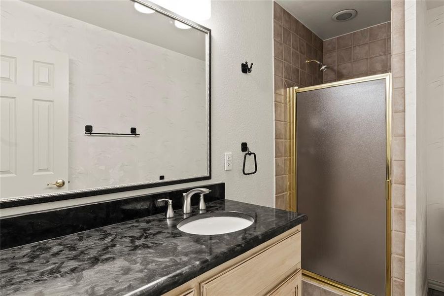 Primary bathroom features separate shower and soaking tub with double sink vanity.