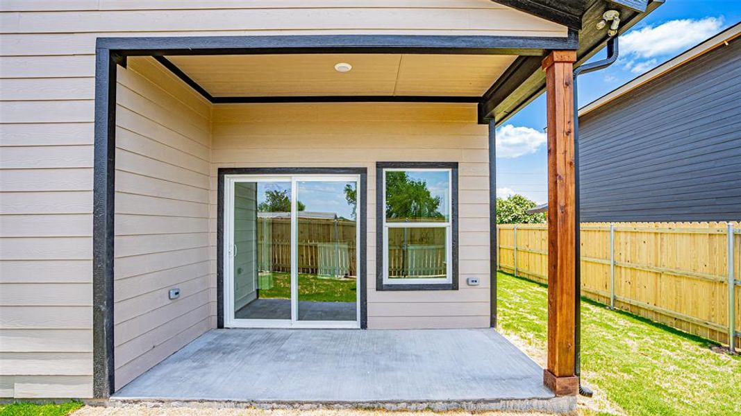 View of back entrance to property, covered patio