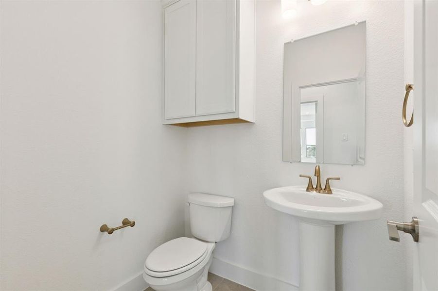 Bathroom featuring toilet and tile patterned flooring