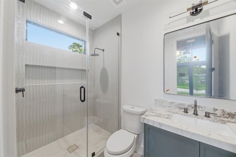 Conveniently located off the main living area, this stylish full guest bath offers both comfort and privacy for visitors.