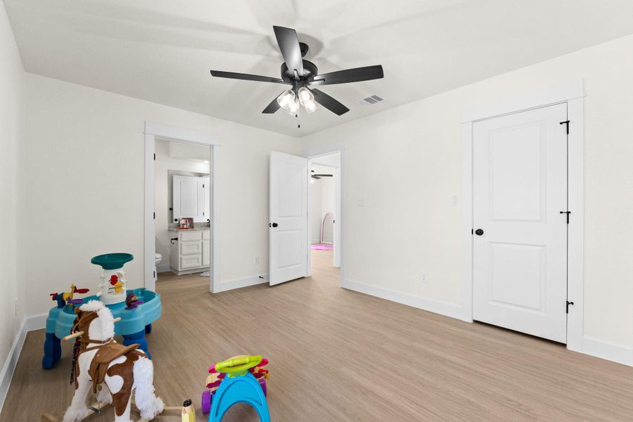 Rec room with light wood finished floors and ceiling fan