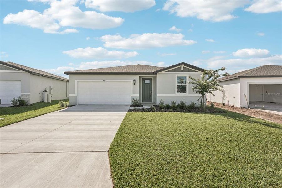 Front exterior of a new home in Salt Meadows - Classic Series, Parrish, FL, highlighting curb appeal (Image 1). Front exterior of a new home in Salt Meadows - Classic Series, Parrish, FL, highlighting curb appeal (Image 1).