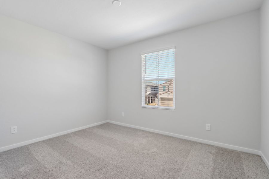 A room with a window and a carpet.