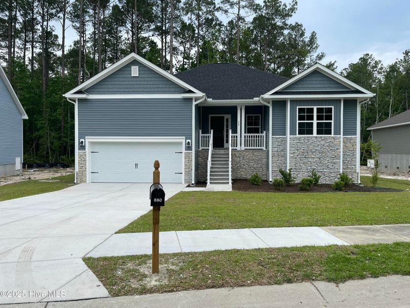 Front exterior of a new home in Mill Creek Cove, Bolivia, NC, highlighting curb appeal (Image 1).