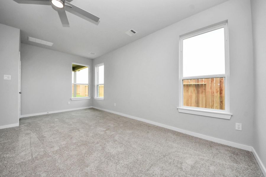 Another perspective unveils a comprehensive view of the serenity and comfort this primary suite offers! Sample photo of completed home with similar floor plan. Actual colors and selections may vary.