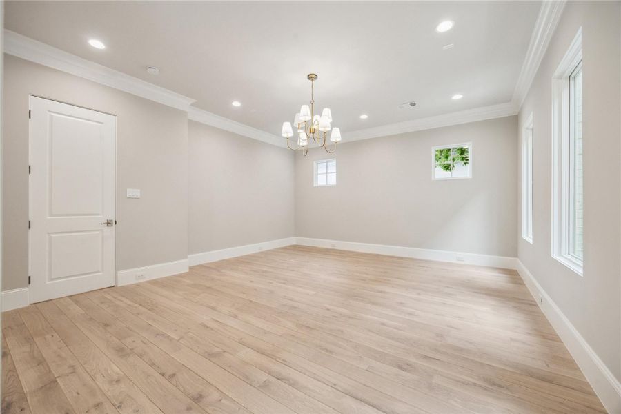 The primary suite is adorned with 10-foot ceilings and a designer light fixture. Exquisite Legno Bastone European White Oak wood floors continue in this space adding to its overall elegance and charm. The primary suite is adorned with 10-foot ceilings and a designer light fixture. Exquisite Legno Bastone European White Oak wood floors continue in this space adding to its overall elegance and charm.