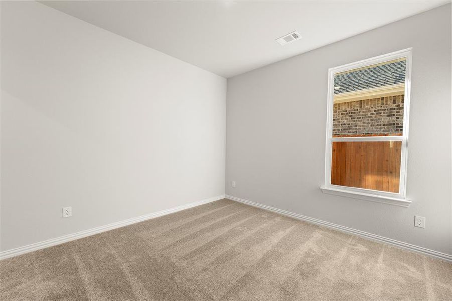 Empty room featuring carpet flooring Empty room featuring carpet flooring